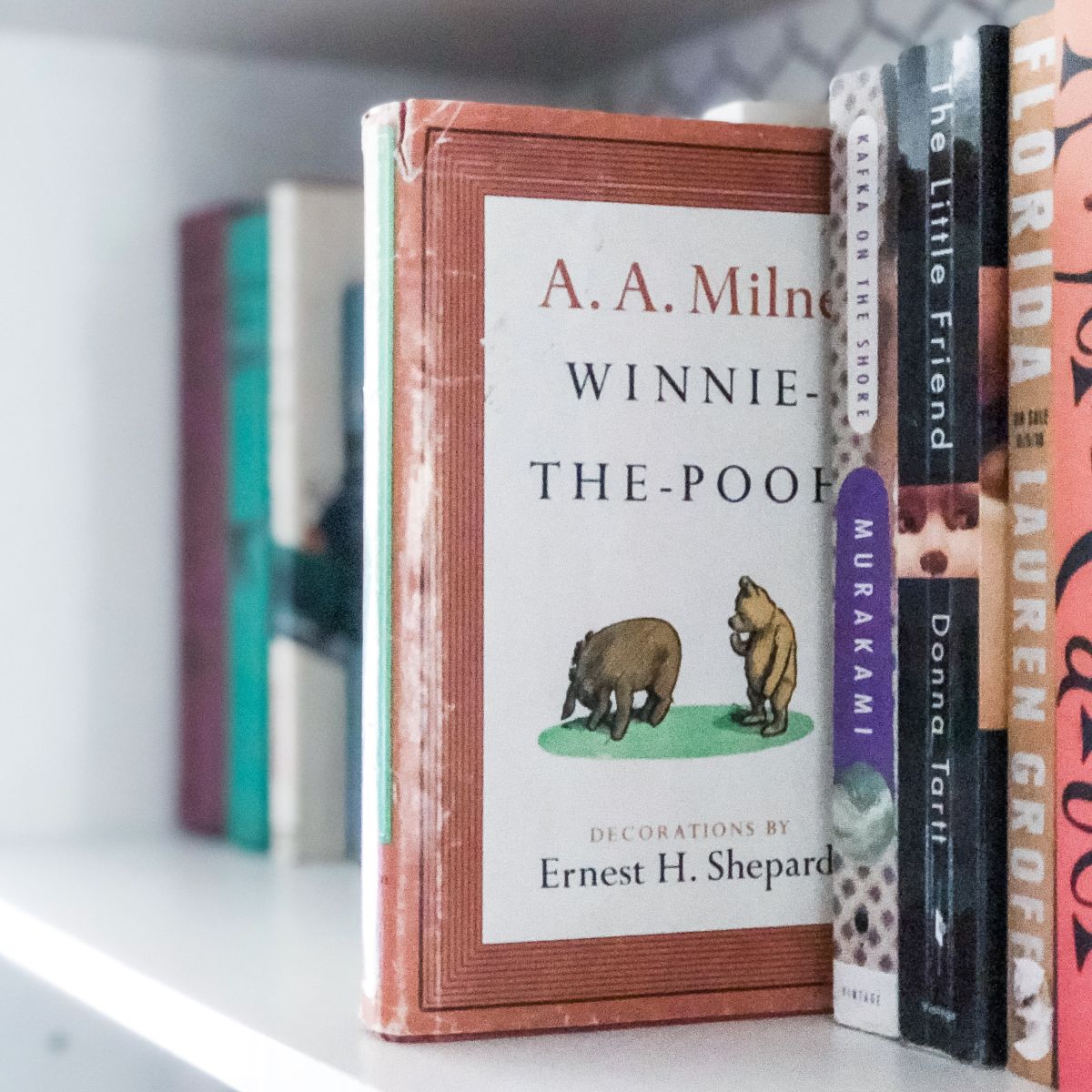 gently used vintage book (Winnie the Pooh by A.A. Milne) on a white bookshelf