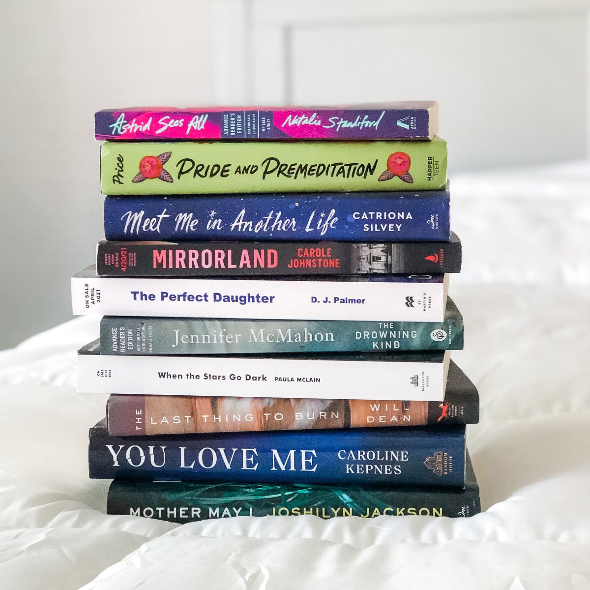 stack of ARC books on a bed