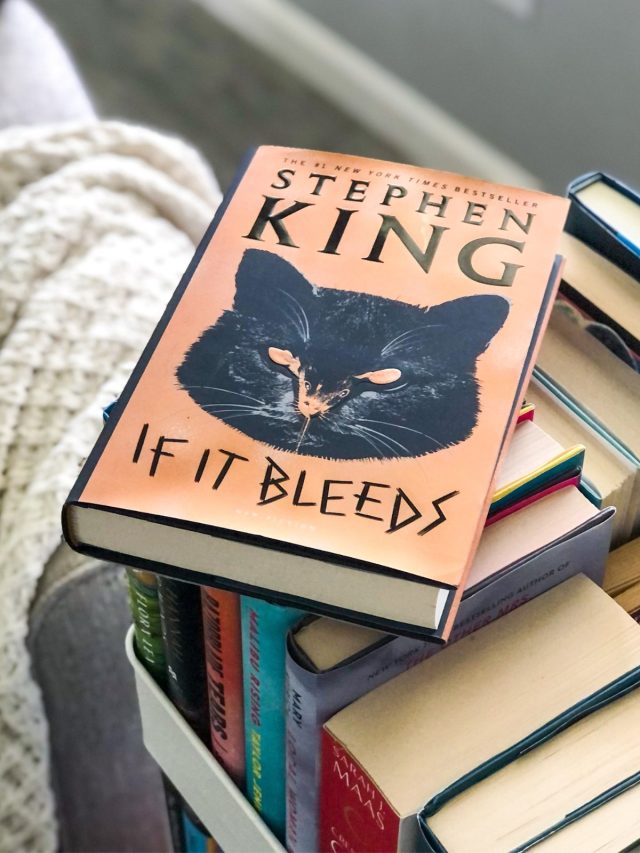 If It Bleeds Holly Gibney book by Stephen King on a book cart with a white blanket