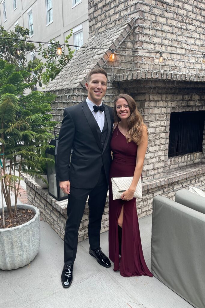 a couple in a tuxedo and gown attending a wedding in Charleston