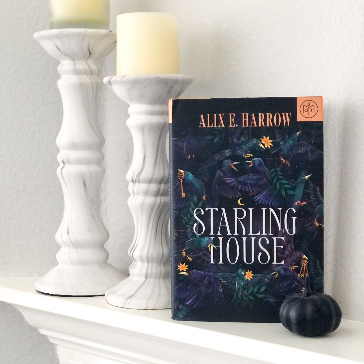 Starling House Gothic fantasy book on a white fireplace mantel with marble candlesticks